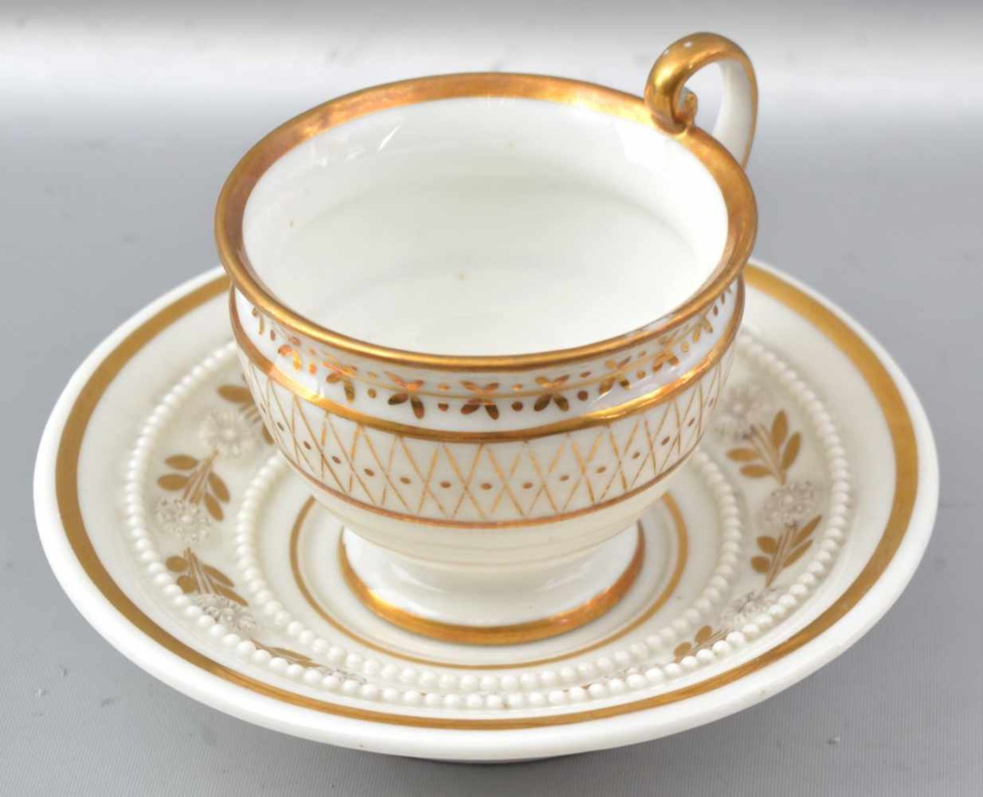 Biedermeier-Tasse mit Untertasse, weiß, Goldrand, Wandung und Spiegel gold verziert, Teller mit