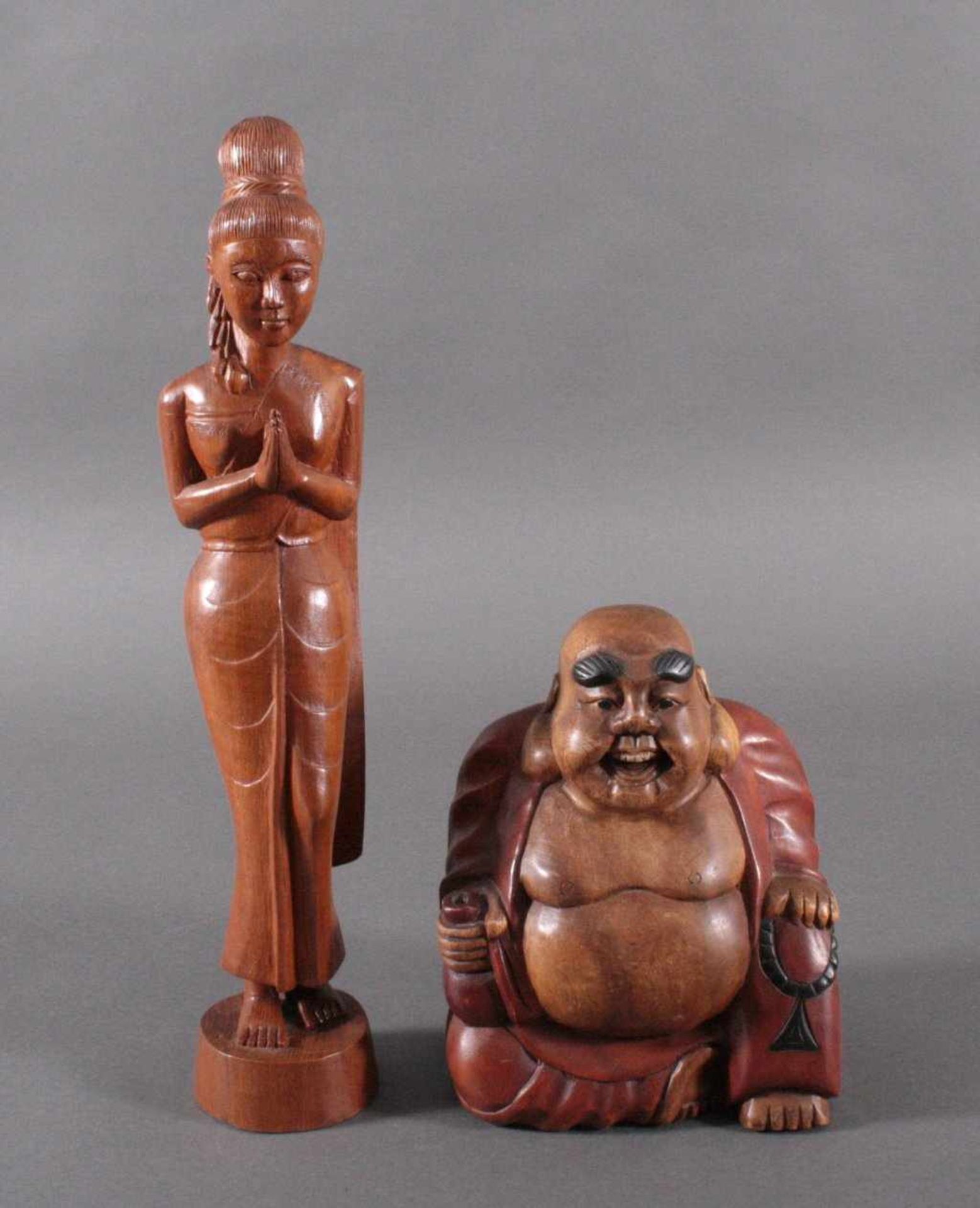 2 asiatische Holzskulpturen1 Buddha, teilweise farbig gefasst, ca. H- 26 cm, sowie eineschlanke