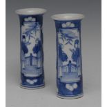 A pair of Chinese sleeve vases, painted in underglaze blue with figures, verso conforming,