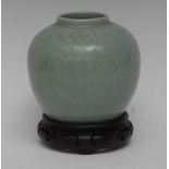 A Chinese celadon ovoid vase, incised with stylised flowers and foliage, 13cm high,