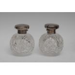 A pair of George V globular scent bottles, hobnail and strawberry cut, the hinged covers,