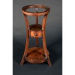 A Biedermeier mahogany waisted tripod washstand, circular aperture, drawer to central tier,