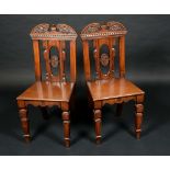 A pair of Victorian Aesthetic Movement mahogany hall chairs,