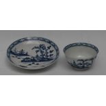 A Worcester Cannon Ball pattern tea bowl and saucer, printed in underglaze blue with pagoda, trees,