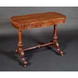 A Victorian rosewood serpentine card table, folding top above a deep frieze,