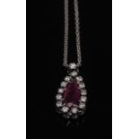 A diamond and ruby pendant, central teardrop pinky red ruby,