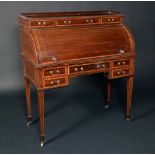 An Edwardian mahogany cylinder desk, three-quarter gallery above three frieze drawers,