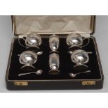 A George V silver six piece condiment set, comprising two pepper pots,