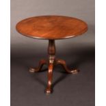 A George III mahogany tripod occasional table, circular top tilting on a bird cage,