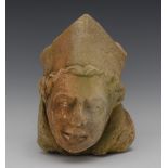 A Medieval limestone corbel, carved with the head of a bishop, 32cm long, 16cm wide, c.