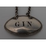 A Victorian silver oval wine label, Gin, engraved lettering, beaded border, 4.