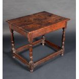 An 18th century oak rectangular side table, planked top above a deep frieze, turned legs,