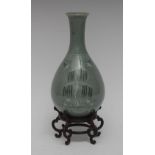 A Japanese celadon bottle vase, decorated with willow, ducks and cranes, 21cm high,