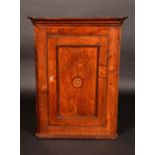 A George III oak splay-fronted wall-hanging corner cupboard,