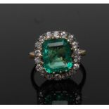 An emerald and diamond cluster ring, central Columbian emerald, measuring 12mm x 10.38mm x 5.