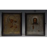 A pair of late 19th century Russian Orthodox parcel-gilt silver and painted icons,