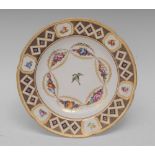 A Derby circular plate, painted with a bird surrounded by sprays of flowers and gilt leafy swags,