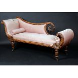 A post-Regency faux rosewood scroll-end day bed, carved with bosses and acanthus,