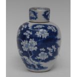 A Chinese ovoid ginger jar and cover, decorated in underglaze blue with blossoming prunus branches,