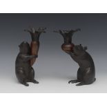 Japanese School, a pair of brown and dark patinated bronze candlesticks,