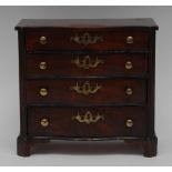 A 19th century mahogany miniature serpentine chest of four long graduated drawers,