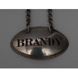 A Victorian silver oval wine label, Brandy, engraved lettering, beaded border, 4.