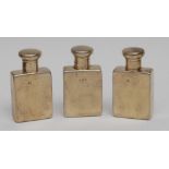 A set of three George V silver-gilt rectangular travelling flasks, domed screw-fitting covers,