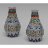 A pair of Chinese ovoid vases, decorated with bands of stylised scrolling foliage,