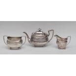A George III silver boat shaped teapot, reeded girdle, banded basket work border, domed cover,