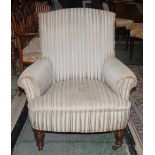 A Victorian walnut armchair, in the manner of Howard & Sons, stuffed-over upholstery, turned legs,