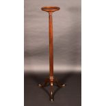 A George III Revival mahogany torchere, dished circular top, fluted column, cabriole legs,