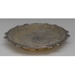 A 19th century Continental silver-gilt shaped circular tazza, well chased with flowers,