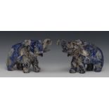 A pair of lapis lazuli carvings, of elephants, each with trunk raised, striding forward,