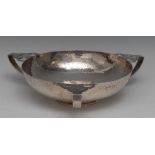 An Arts and Crafts silver three-handled fruit bowl, planished overall,