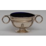 An Edwardian silver two handled bowl, applied with half girdle and stiff Celtic straps,