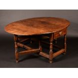 An early 18th century oak oval gateleg dining-table, of broad proportions, oversailing top,