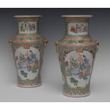 A pair of Chinese Famille Verte ovoid vases, painted with elders seated around a table,