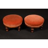 A pair of Victorian walnut circular foot stools, stuffed-over upholstery, turned,