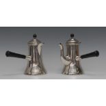 A pair of late Victorian silver spreading cylindrical cafe-au-lait pots,