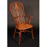 A 19th century elm Windsor elbow chair, hooped back with shaped and pierced 'Christmas tree' splat,