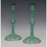 A pair of 18th century Bilston Rococo enamel candlesticks, of silver form, plain sconces,