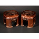 A pair of Chinese hardwood canted square jardiniere stands,