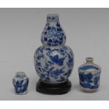 A Chinese double gourd vase, decorated overall in underglaze blue with stylised flowers and foliage,