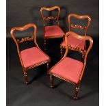 A set of four Victorian mahogany kidney back dining chairs, C-scroll central rails, drop-in seats,