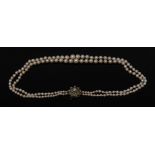 A cultured pearl graduated two strand necklace, each individually knotted,