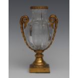 An ormolu mounted crystal fluted ovoid vase, the handles cast as intertwined scrolling vine,
