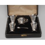 An Art Deco silver five piece geometric condiment set, comprising a pair of peppers,