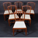 A set of six George III mahogany dining chairs, arched backs with lotus-capped splats,