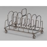 A George III silver seven-bar toast rack, rounded rectangular handle, rounded octagonal divisions,