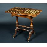 A Victorian walnut serpentine games table, folding top enclosing a plateau inlaid for chess,